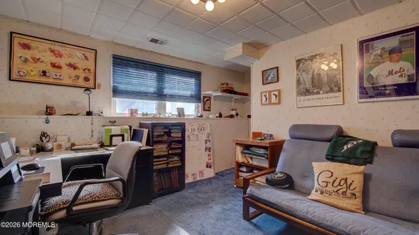 a view of a workspace with furniture and a window