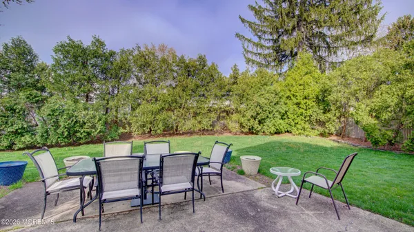 a view of a chairs and table in the yard