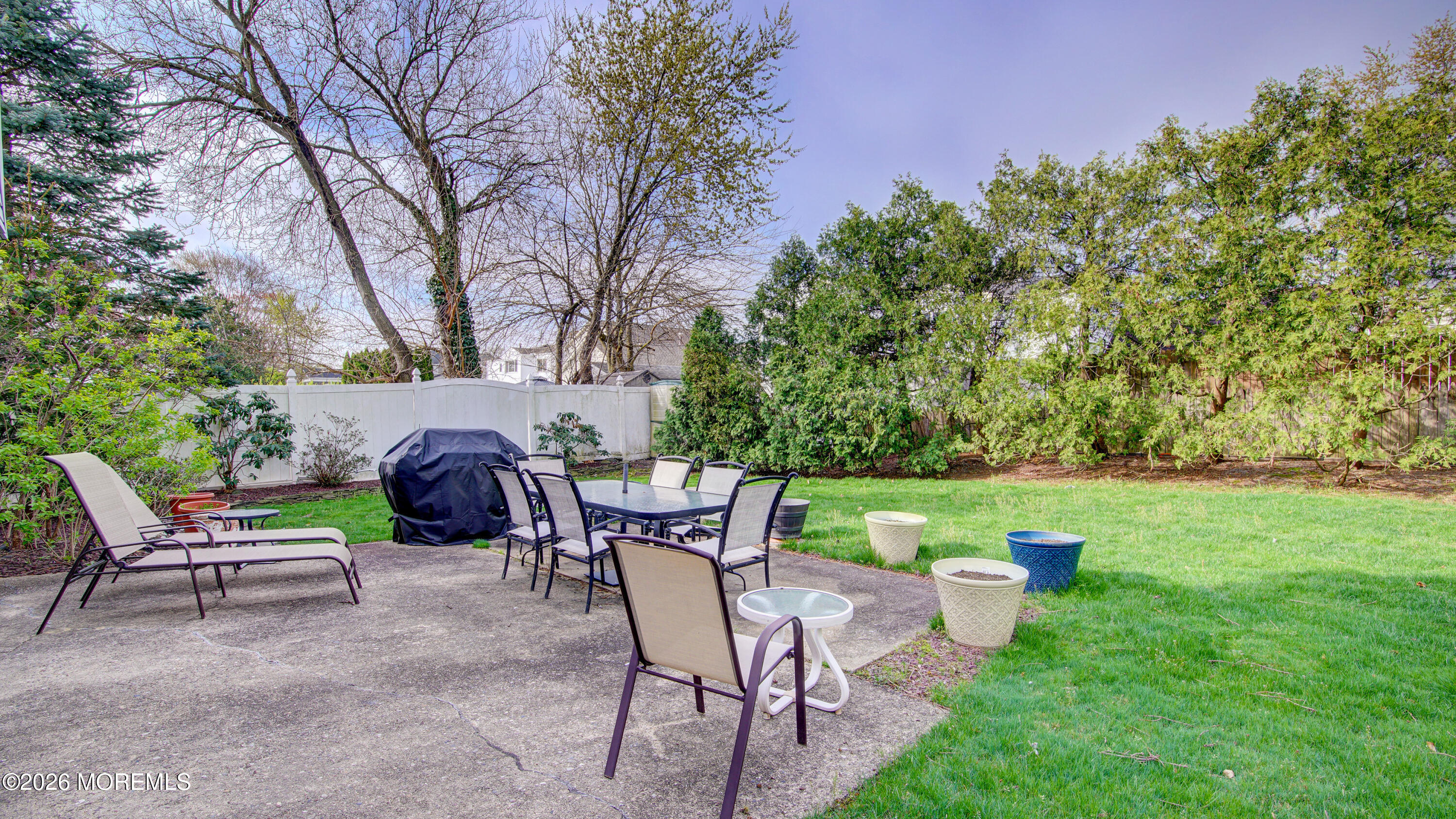 12 Cavan Lane Hazlet, NJ 07730 - Photo 33 of 34 a view of a patio with table and chairs potted plants and a large tree
