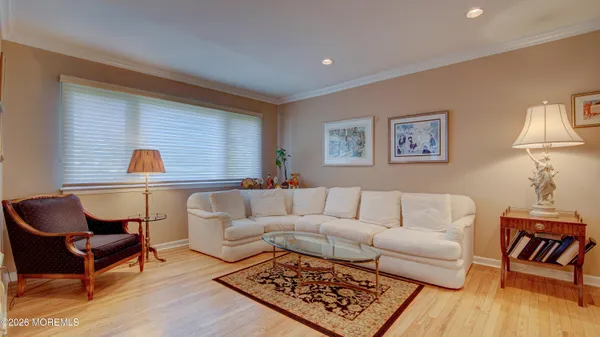 a living room with furniture and a lamp