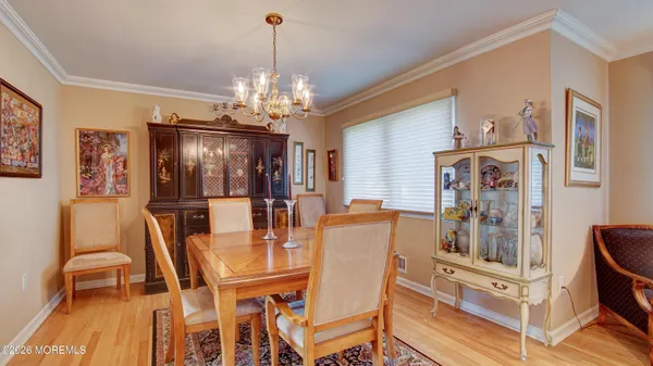 a view of a dining room with furniture and chandelier