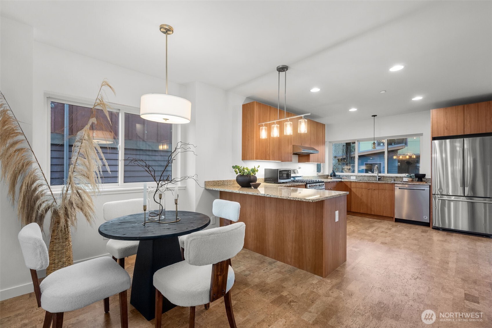 1402 194th Street Southeast, Unit 1 Bothell, WA 98012 - Photo 11 of 31 a kitchen with stainless steel appliances kitchen island a table and chairs in it