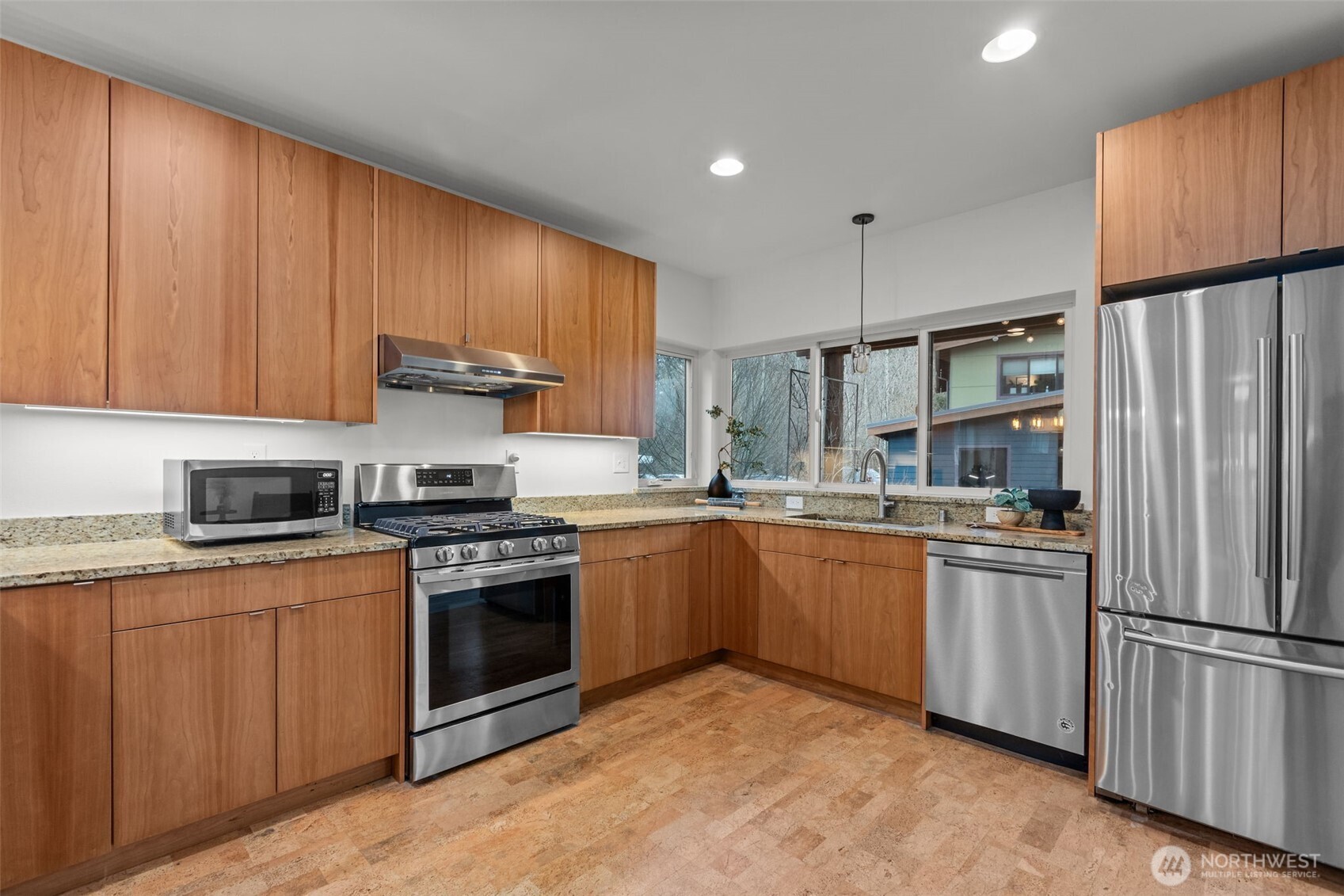 1402 194th Street Southeast, Unit 1 Bothell, WA 98012 - Photo 12 of 31 a kitchen with stainless steel appliances granite countertop a stove top oven a refrigerator and white cabinets