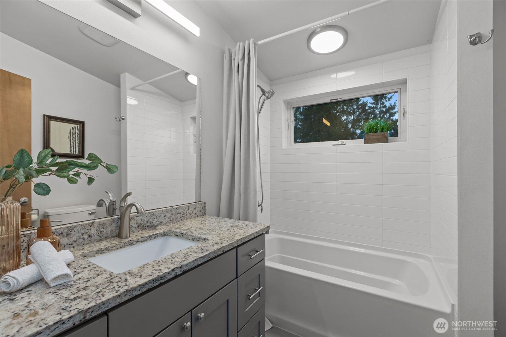 1402 194th Street Southeast, Unit 1 Bothell, WA 98012 - Photo 21 of 31 a bathroom with a granite countertop sink and a mirror