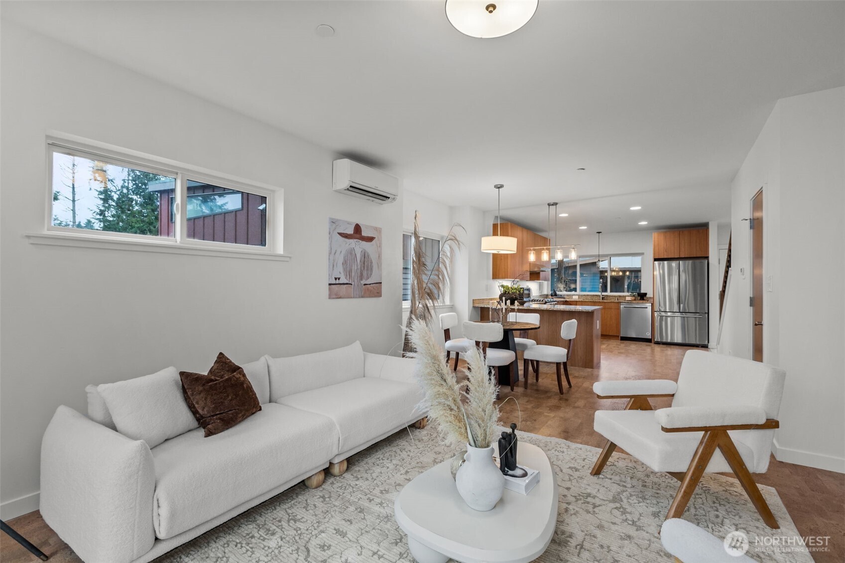 1402 194th Street Southeast, Unit 1 Bothell, WA 98012 - Photo 6 of 31 a living room with furniture and a dining table with kitchen view