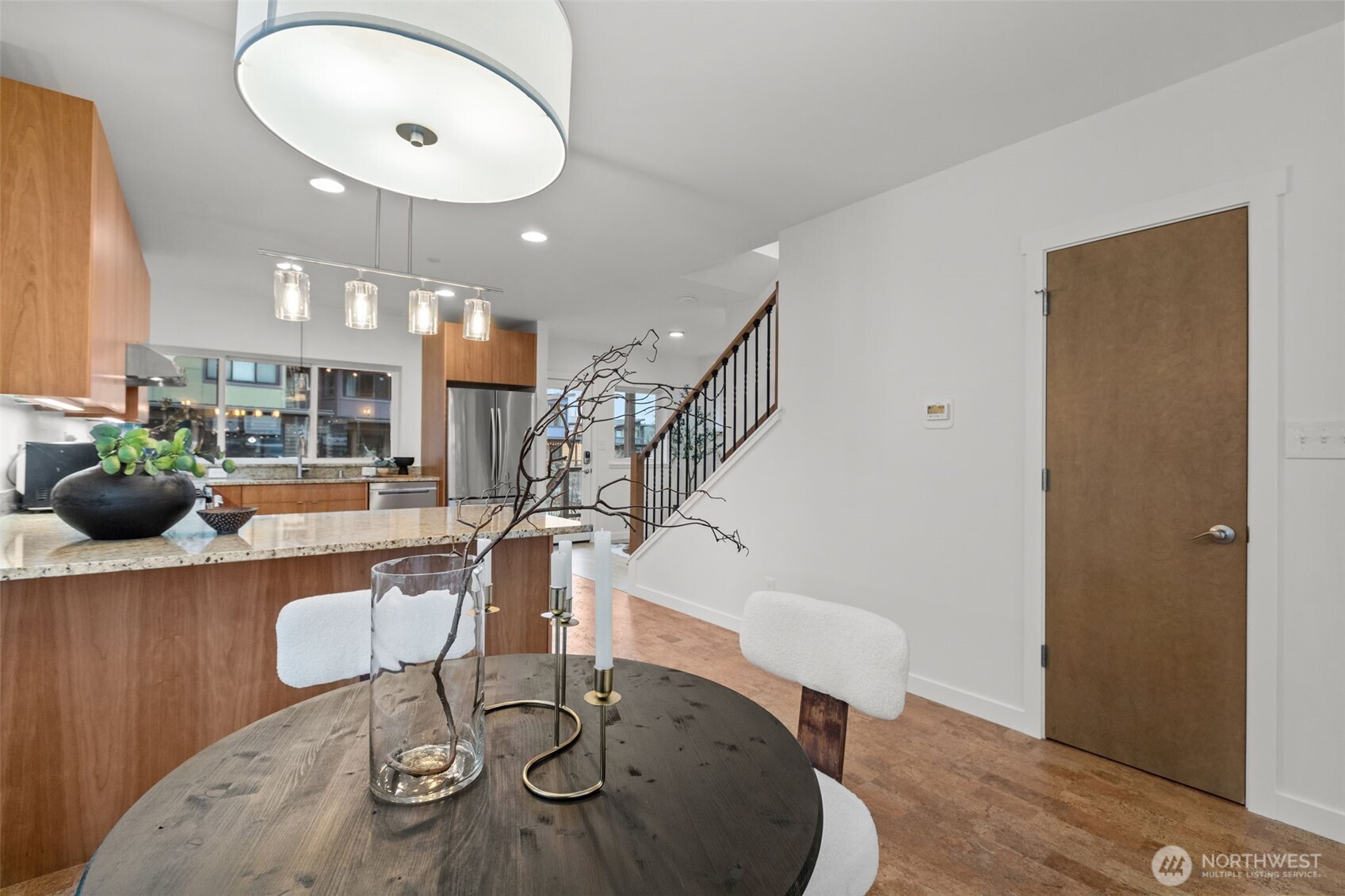 1402 194th Street Southeast, Unit 1 Bothell, WA 98012 - Photo 10 of 31 a view of a dining room with furniture a chandelier and wooden floor