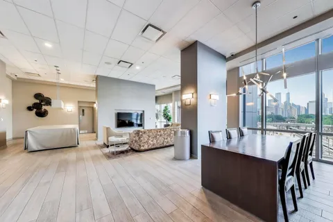 a large kitchen with kitchen island a large island a sink a stove and wooden floor
