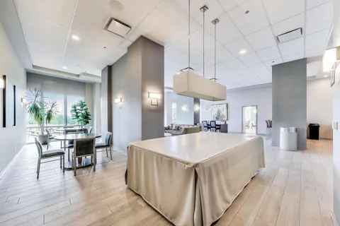 a kitchen with stainless steel appliances granite countertop a refrigerator a sink and a counter top space