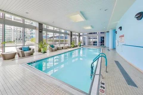 a view of swimming pool with outdoor seating and plants