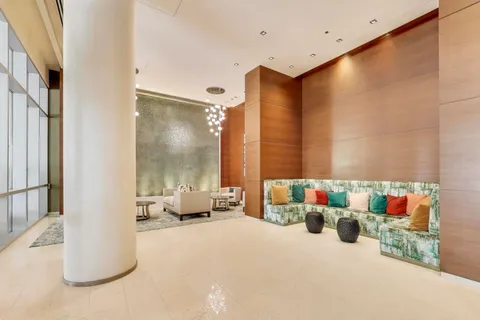 a living room with furniture and a large mirror