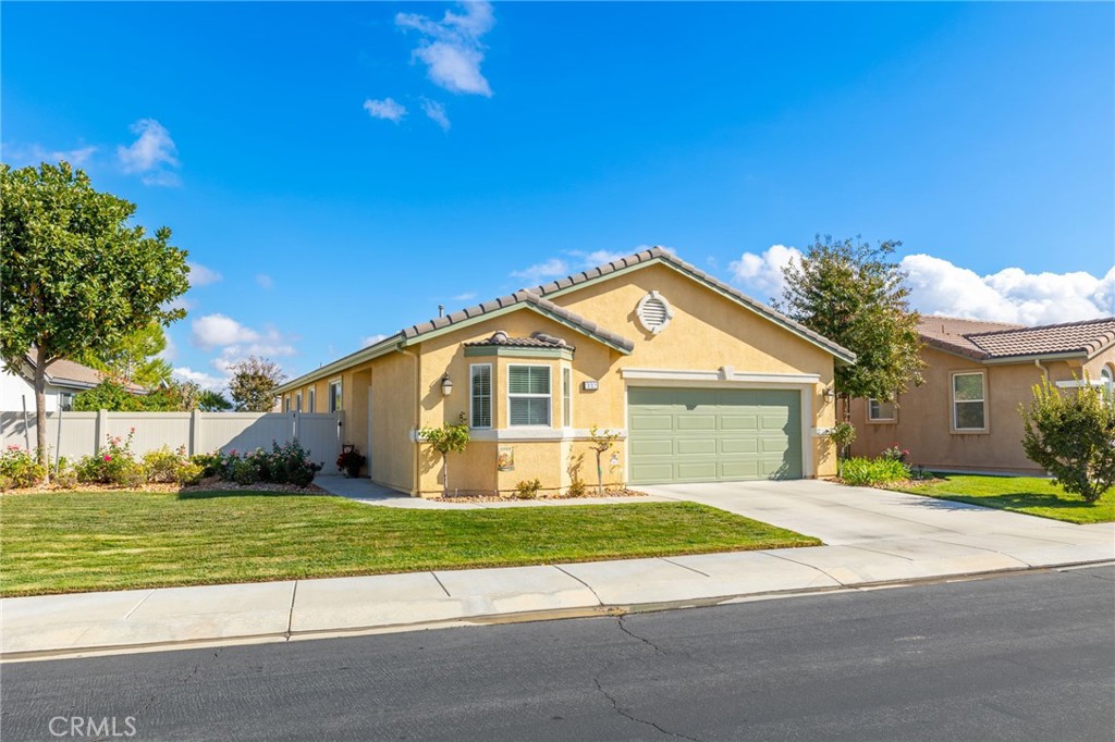 332 Shining Rock Beaumont, CA 92223 - Photo 1 of 1 a front view of a house with a yard and garage