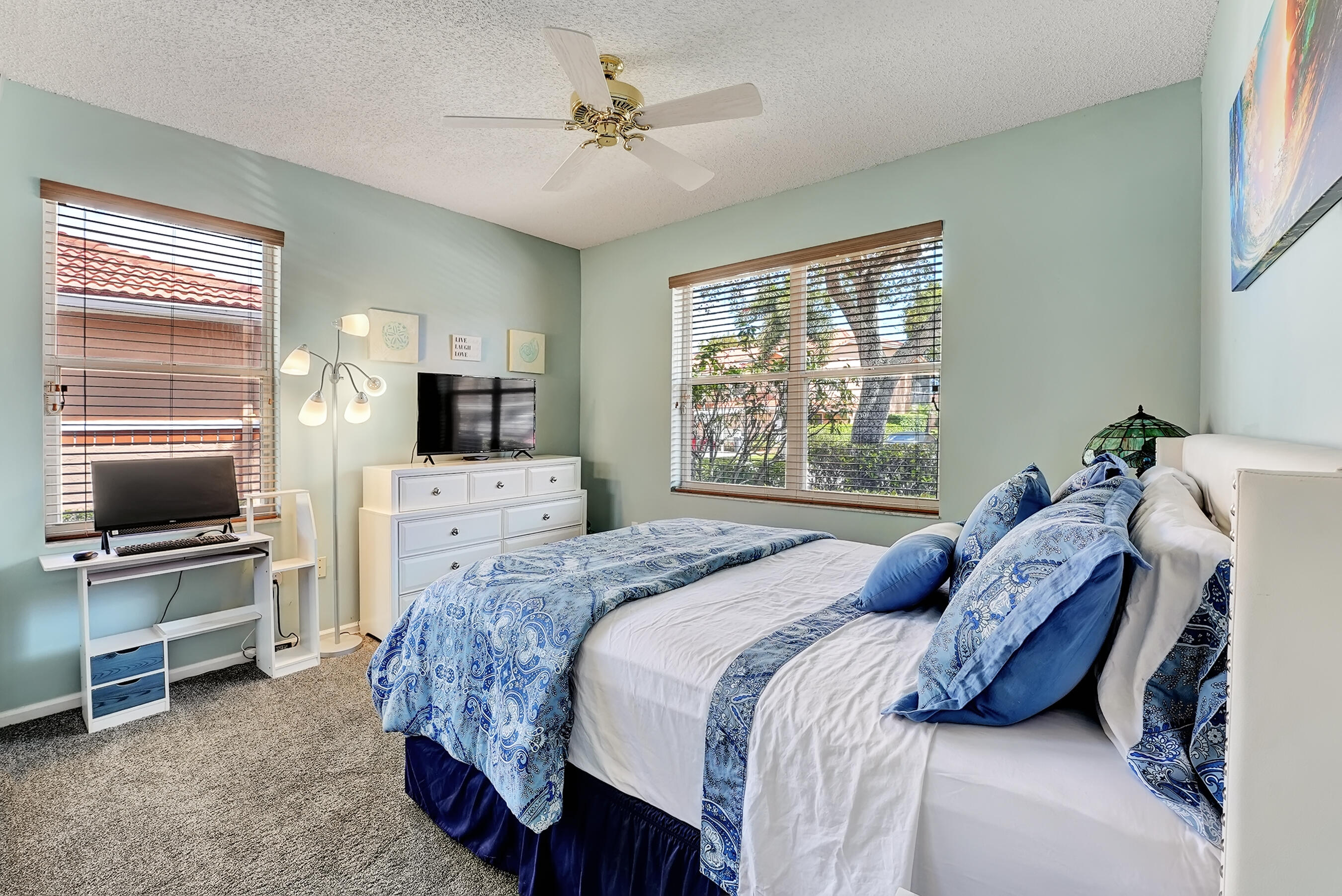 9944 Seacrest Circle, Unit D Boynton Beach, FL 33437 - Photo 22 of 35 a bedroom with a bed television on desk and a window