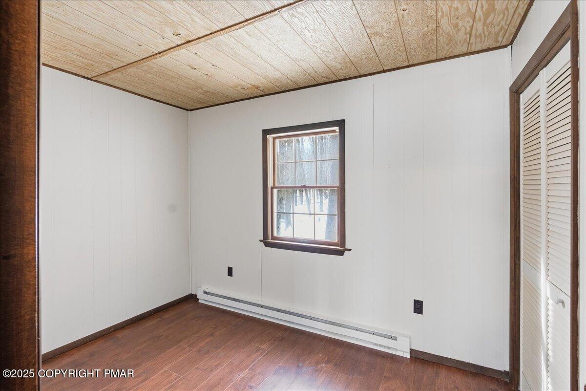 13 Sheffick Road Gouldsboro, PA 18424 - Photo 20 of 38 a view of an empty room with wooden floor and a window