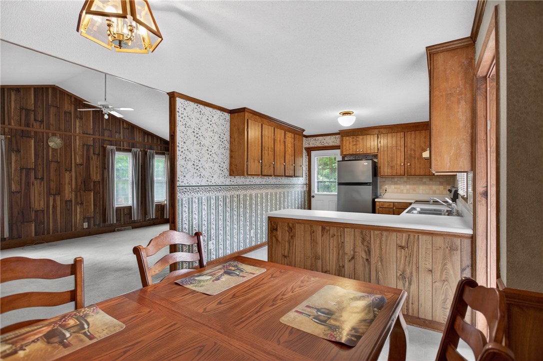 112 Holliday Lane Pendleton, SC 29670 - Photo 16 of 42 A welcoming dining area seamlessly connects to a compact kitchen, perfect for entertaining.