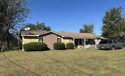 a front view of a house with yard and garage