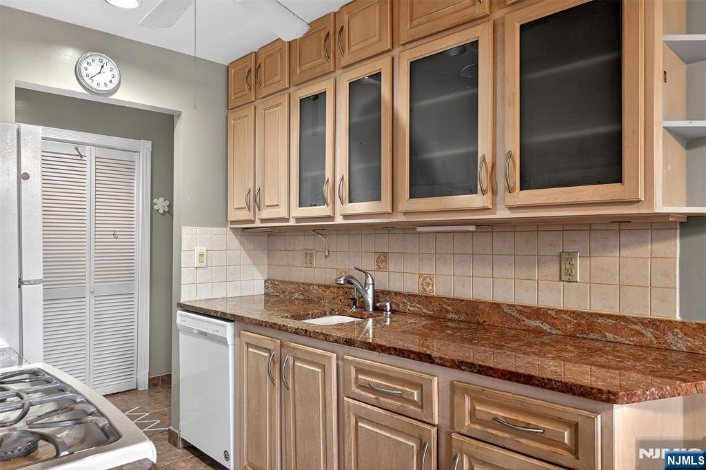 333 Liberty Street, Unit 4 Little Ferry, NJ 07643 - Photo 11 of 29 a kitchen with stainless steel appliances granite countertop a sink and cabinets with wooden floor
