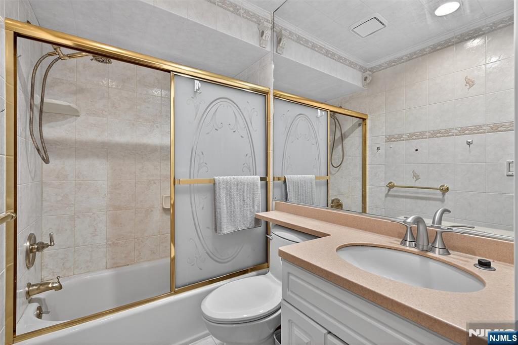 333 Liberty Street, Unit 4 Little Ferry, NJ 07643 - Photo 17 of 29 a bathroom with a granite countertop sink toilet and shower