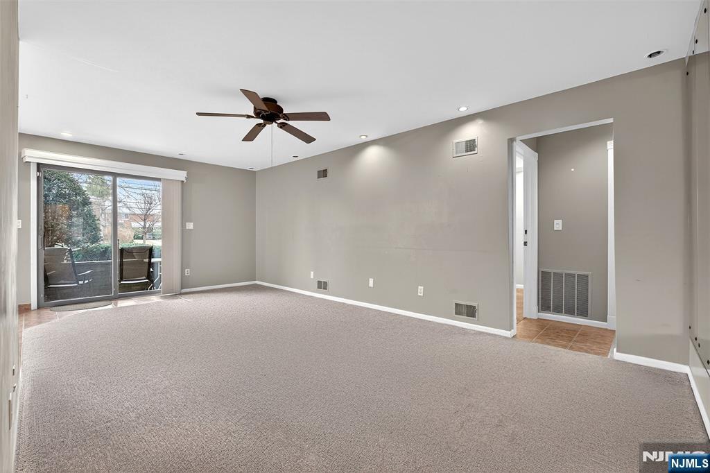 333 Liberty Street, Unit 4 Little Ferry, NJ 07643 - Photo 20 of 29 an empty room with chandelier fan and windows