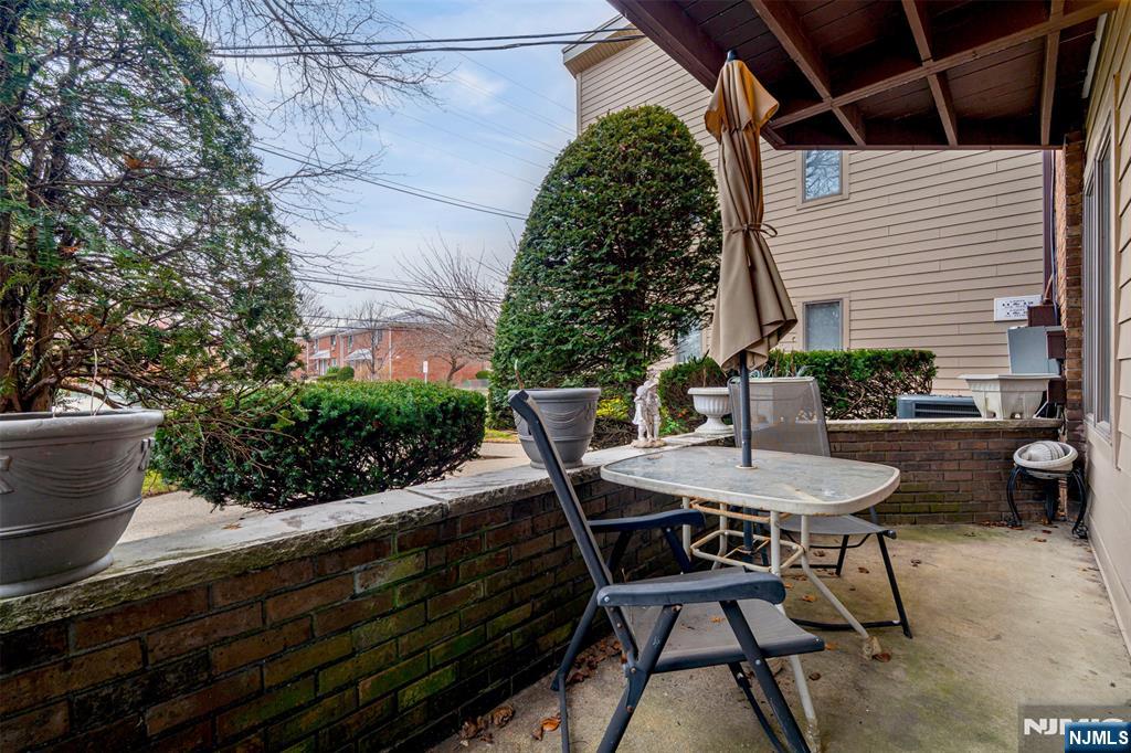 333 Liberty Street, Unit 4 Little Ferry, NJ 07643 - Photo 26 of 29 a roof deck with table and chairs and potted plants