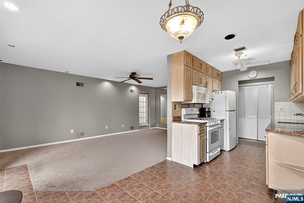 333 Liberty Street, Unit 4 Little Ferry, NJ 07643 - Photo 6 of 29 a kitchen with stainless steel appliances a stove a refrigerator and a chandelier