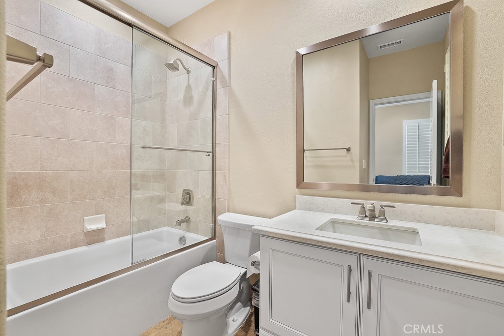 89 Lavender Lake Forest, CA 92630 - Photo 26 of 45 a bathroom with a granite countertop sink a toilet and shower