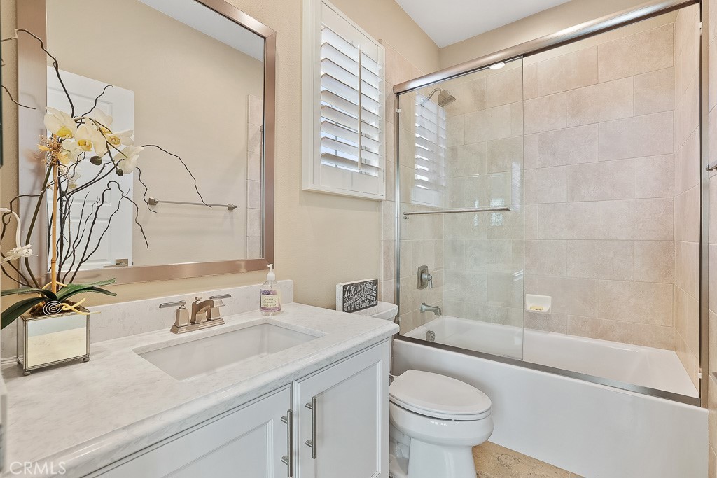 89 Lavender Lake Forest, CA 92630 - Photo 28 of 45 a bathroom with a granite countertop sink a toilet and shower