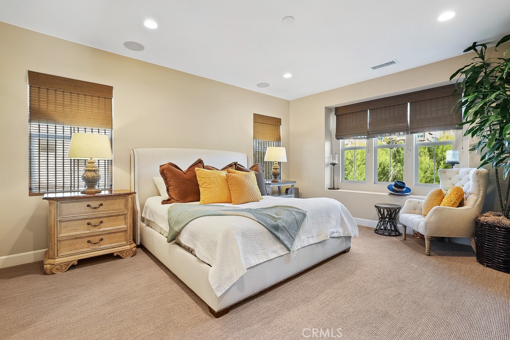 89 Lavender Lake Forest, CA 92630 - Photo 30 of 45 a spacious bedroom with a bed and large windows