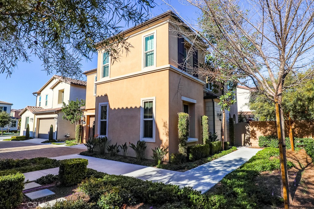 89 Lavender Lake Forest, CA 92630 - Photo 4 of 45 a view of a white house next to a yard with plants and trees