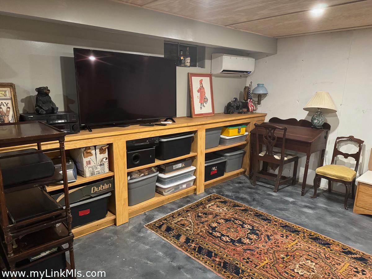 8 Old Purchase Road Edgartown, MA 02539 - Photo 22 of 26 a room with furniture a flat screen tv and a table