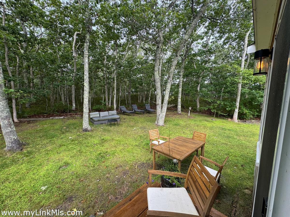 8 Old Purchase Road Edgartown, MA 02539 - Photo 25 of 26 a backyard of a house with garden view and furniture