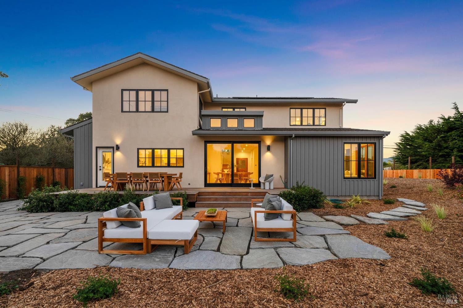 a view of a house with couches chairs and a yard