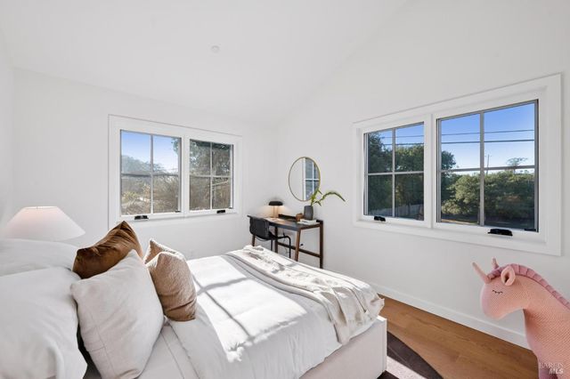 a bedroom with a bed and a large window with outer view