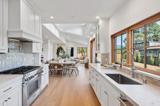 a large kitchen with a large window and stainless steel appliances