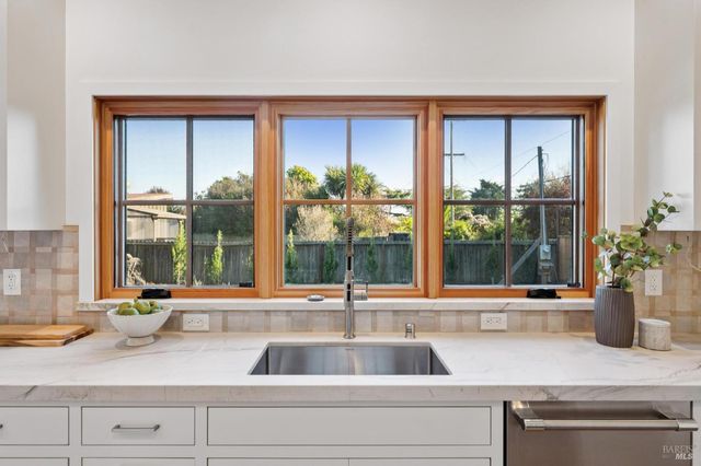 a kitchen with a sink and large window