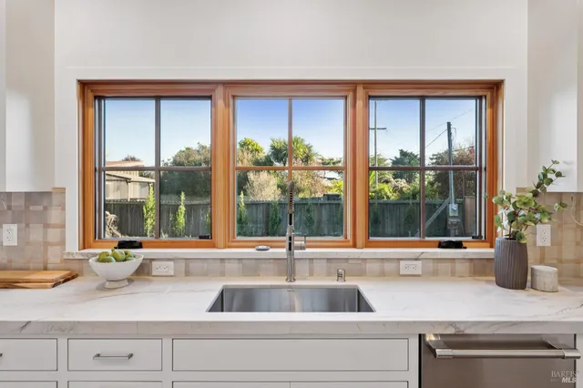 a kitchen with a sink and large window