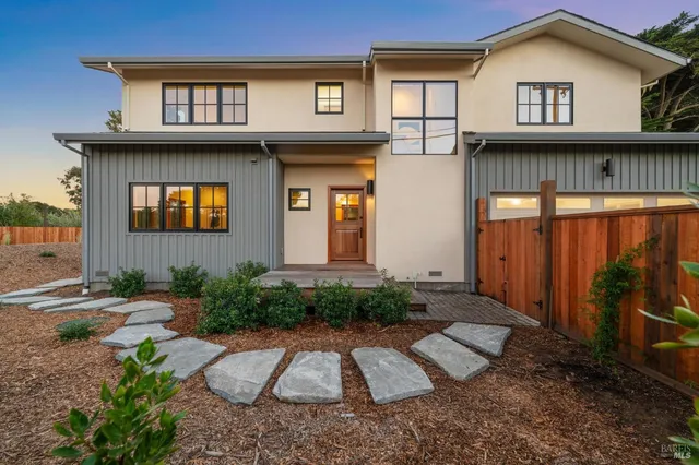 a front view of a house with garden