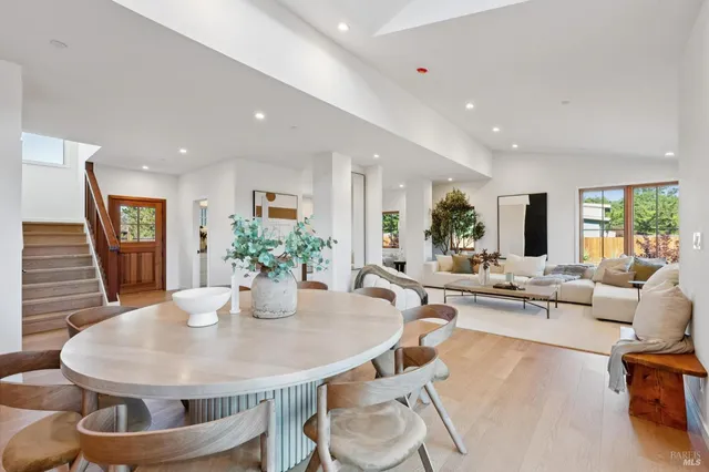 a view of a dining room with furniture and floor to ceiling window