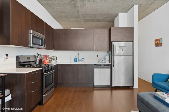 a kitchen with a refrigerator and a stove top oven