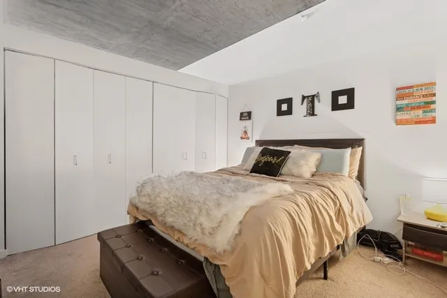 a bedroom with a bed and cabinets
