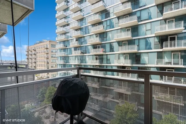 a roof deck with table and chairs