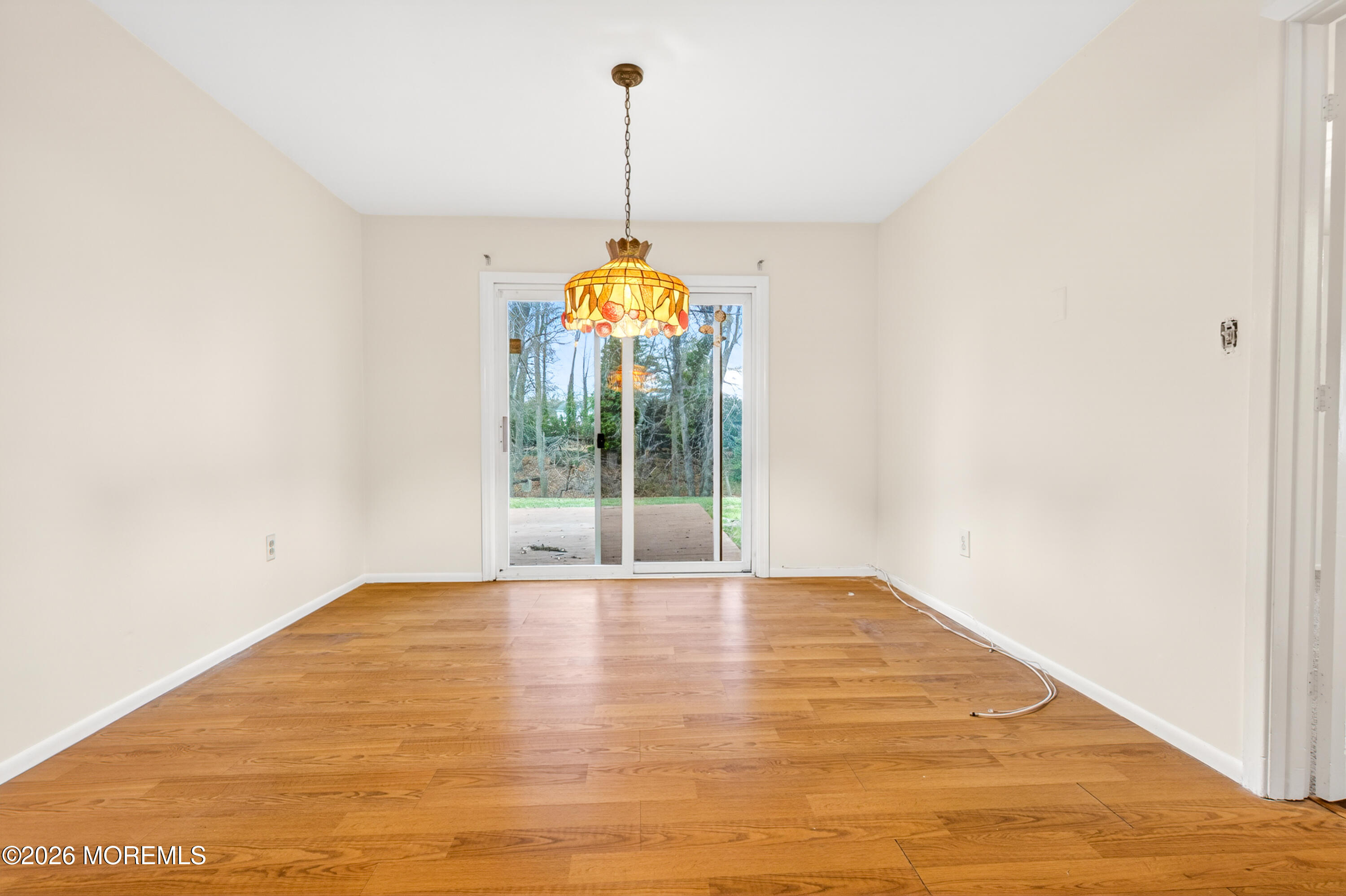 120 Andover Lane Matawan, NJ 07747 - Photo 27 of 35 a view of an empty room with window and chandelier fan