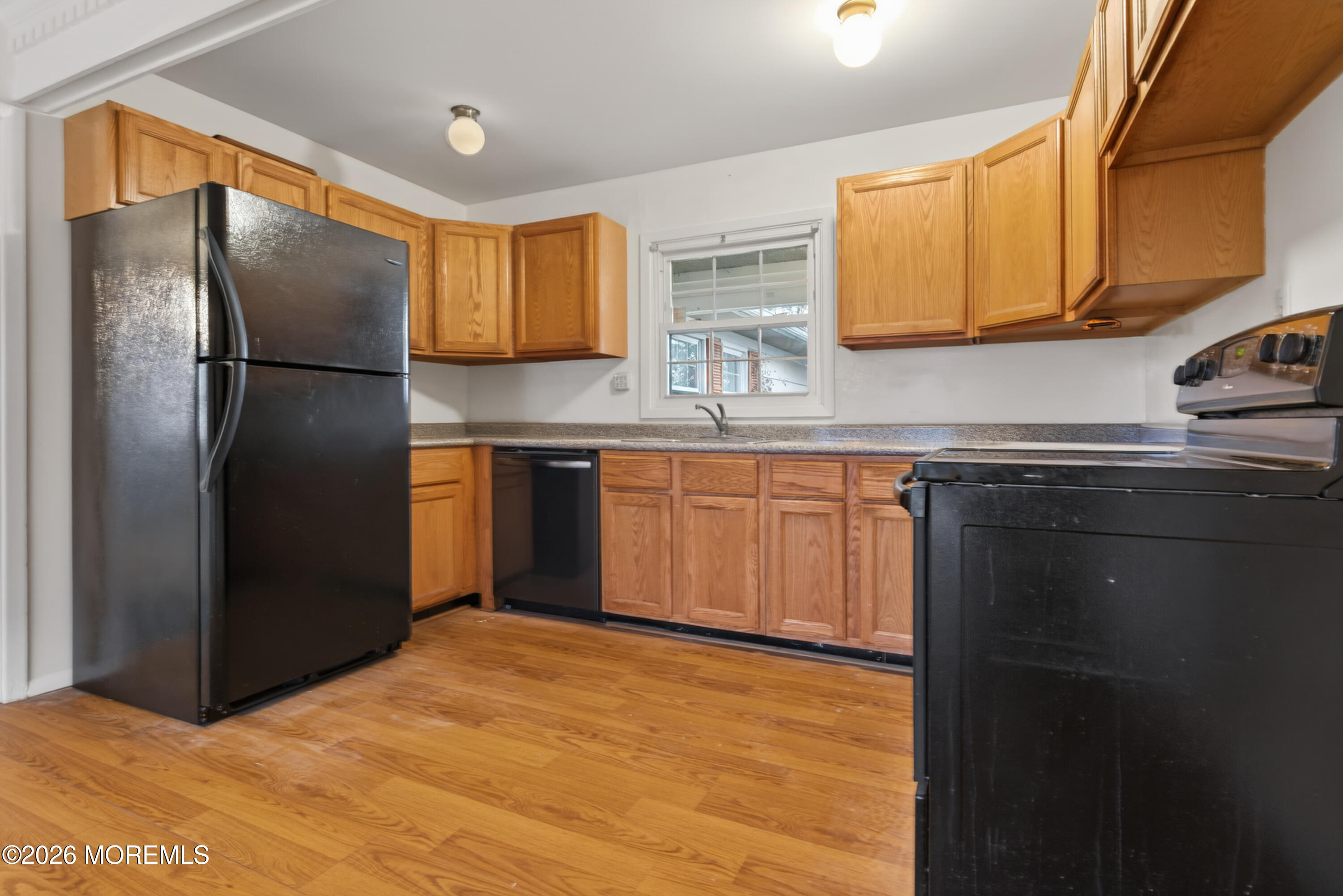 120 Andover Lane Matawan, NJ 07747 - Photo 9 of 35 a kitchen with stainless steel appliances granite countertop a refrigerator a sink dishwasher a stove with wooden cabinets