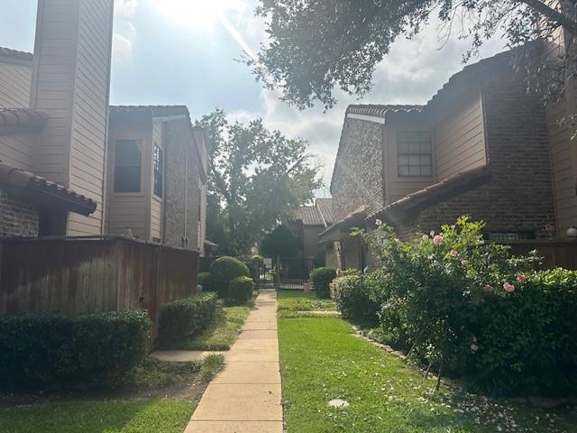 5626 Preston Oaks Road, Unit 5D Dallas, TX 75254 - Photo 25 of 29 a view of a pathway both side of flower buildings