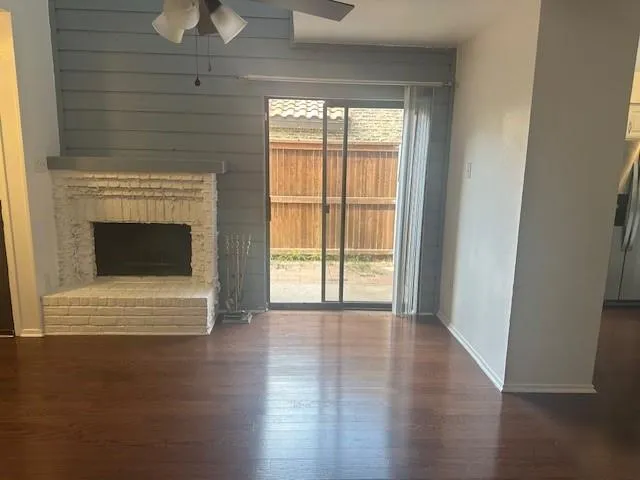 a view of a small space with wooden floor and a ceiling fan