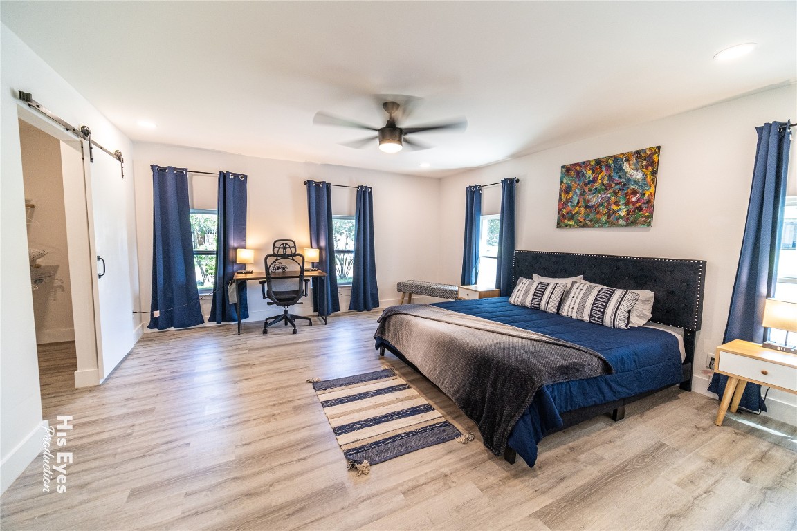 7500 Rio Pass Austin, TX 78724 - Photo 4 of 38 a spacious bedroom with a bed and a table in it