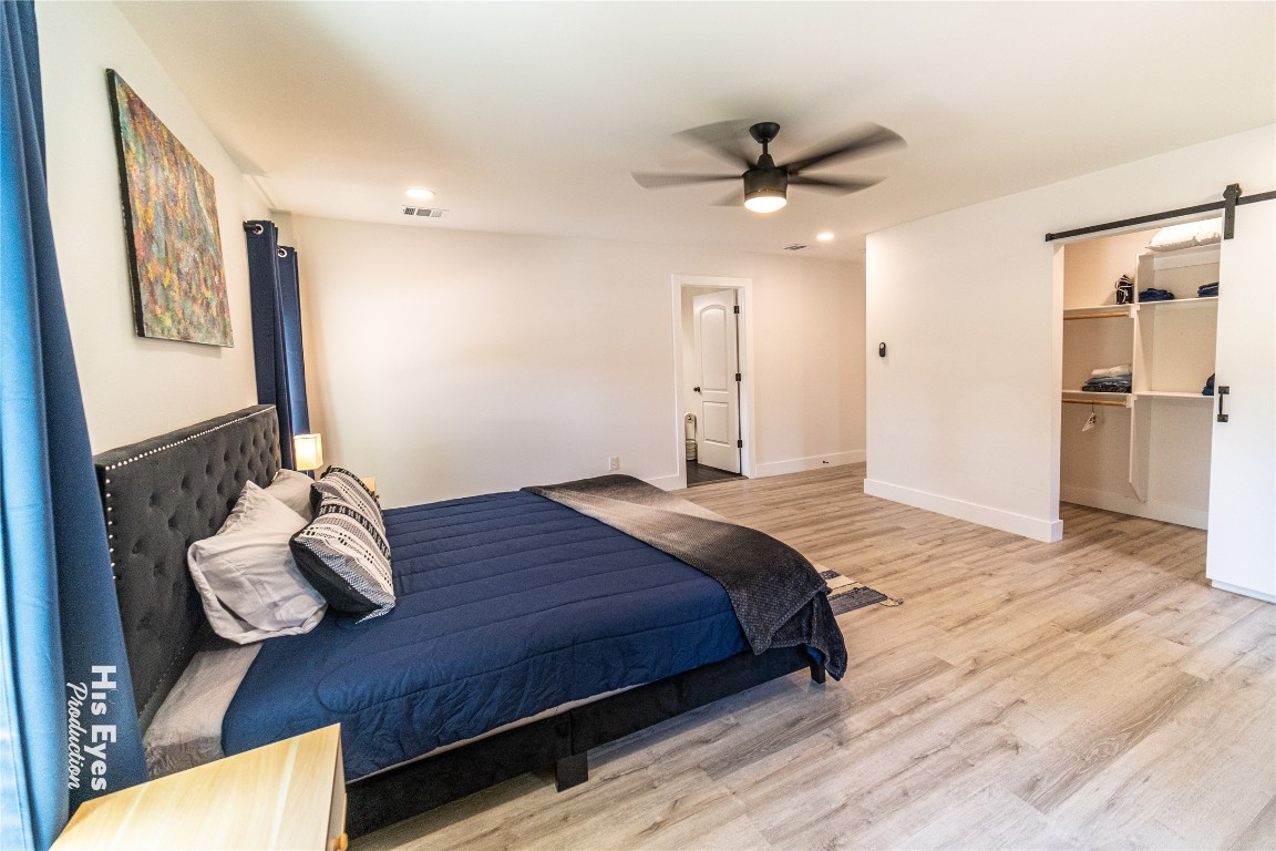 7500 Rio Pass Austin, TX 78724 - Photo 7 of 38 a bedroom with a bed and a chandelier