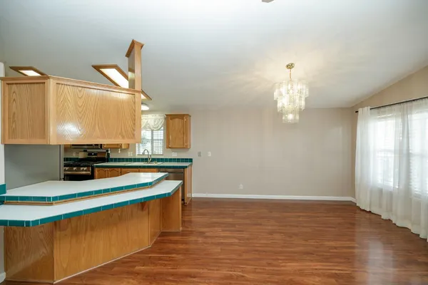 a room with table chairs and wooden floor