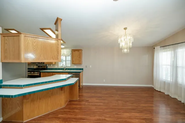 a room with table chairs and wooden floor