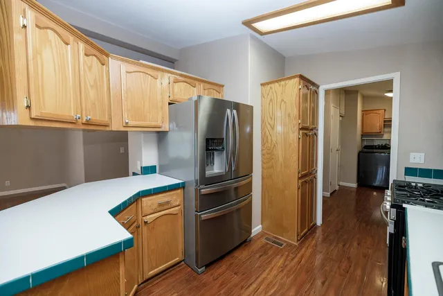 a kitchen with stainless steel appliances a refrigerator and a stove top oven