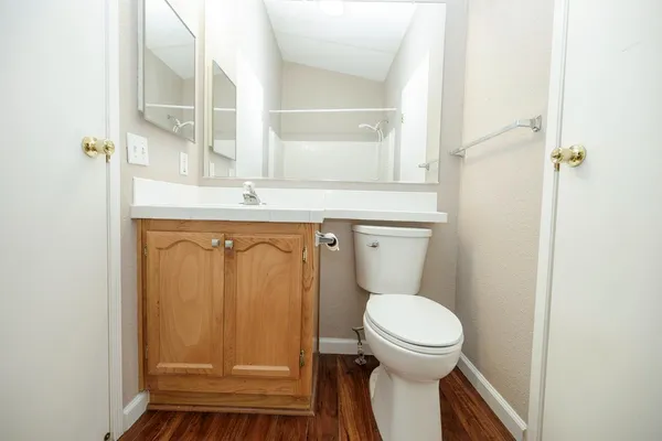 a bathroom with a toilet a sink and a window